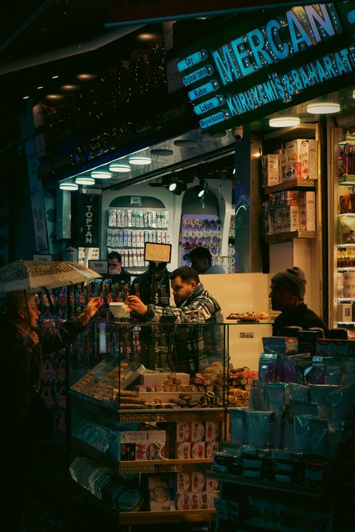 Free A bustling street food market scene in Istanbul at night with colorful lights and diverse products on display. Stock Photo