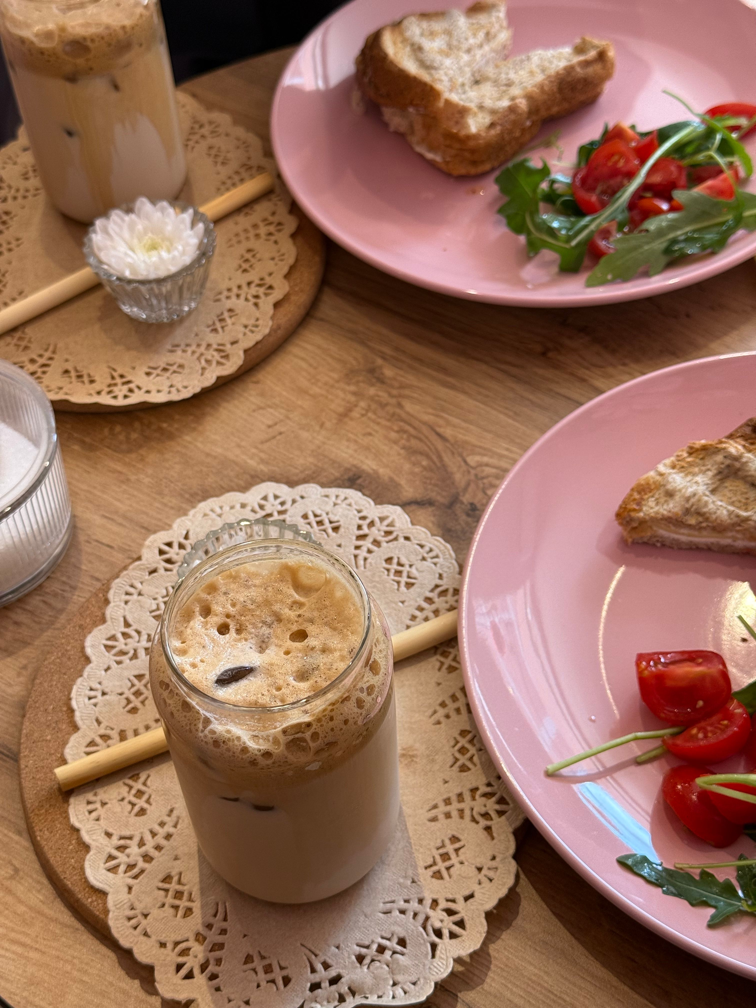 Enjoy a relaxing brunch with iced coffee, fresh salad, and toast. Perfect meal for a cozy day.