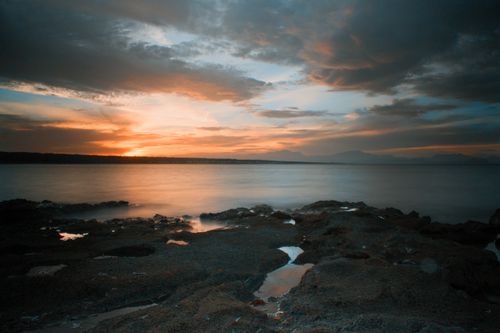 Free Breathtaking view of a serene sunset over the rocky coastline of the Balearic Islands, Spain. Stock Photo
