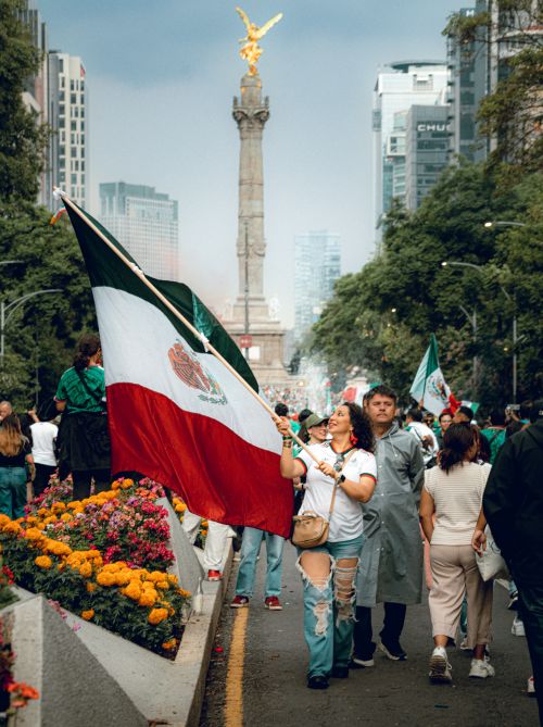 Free Citizens parade with flags on Avenida Reforma in Mexico City, displaying national pride. Stock Photo