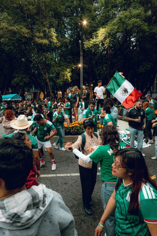 Free Festive gathering in Ciudad de México with people waving Mexican flags and wearing team jerseys. Stock Photo