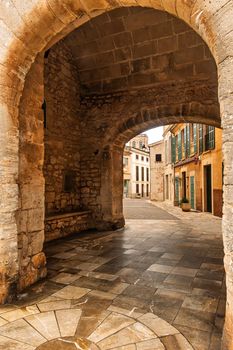 Discover the rustic charm of Santanyí's historic stone architecture through this inviting archway.
