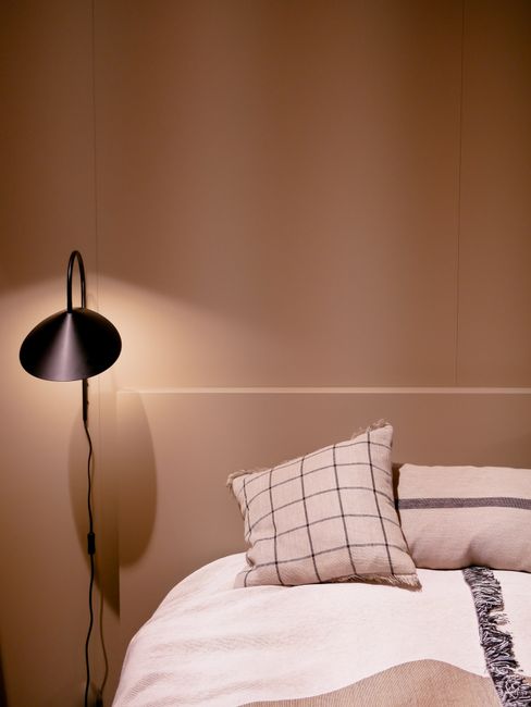 Stylish bedroom with contemporary design elements, featuring warm lighting and chic decor.