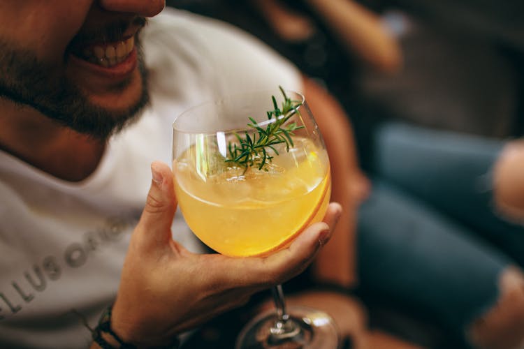 Crop Man Proposing Toast With Cocktail