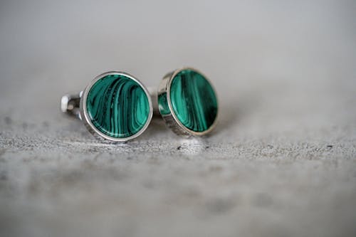 Verdant earrings placed on paved road