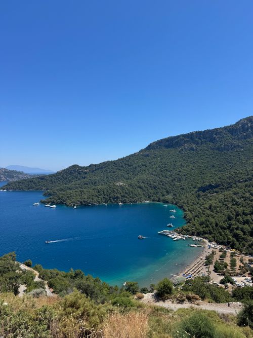 Free Stunning aerial view of the turquoise coastline along Göcek, with lush green hills and boats in clear waters. Stock Photo