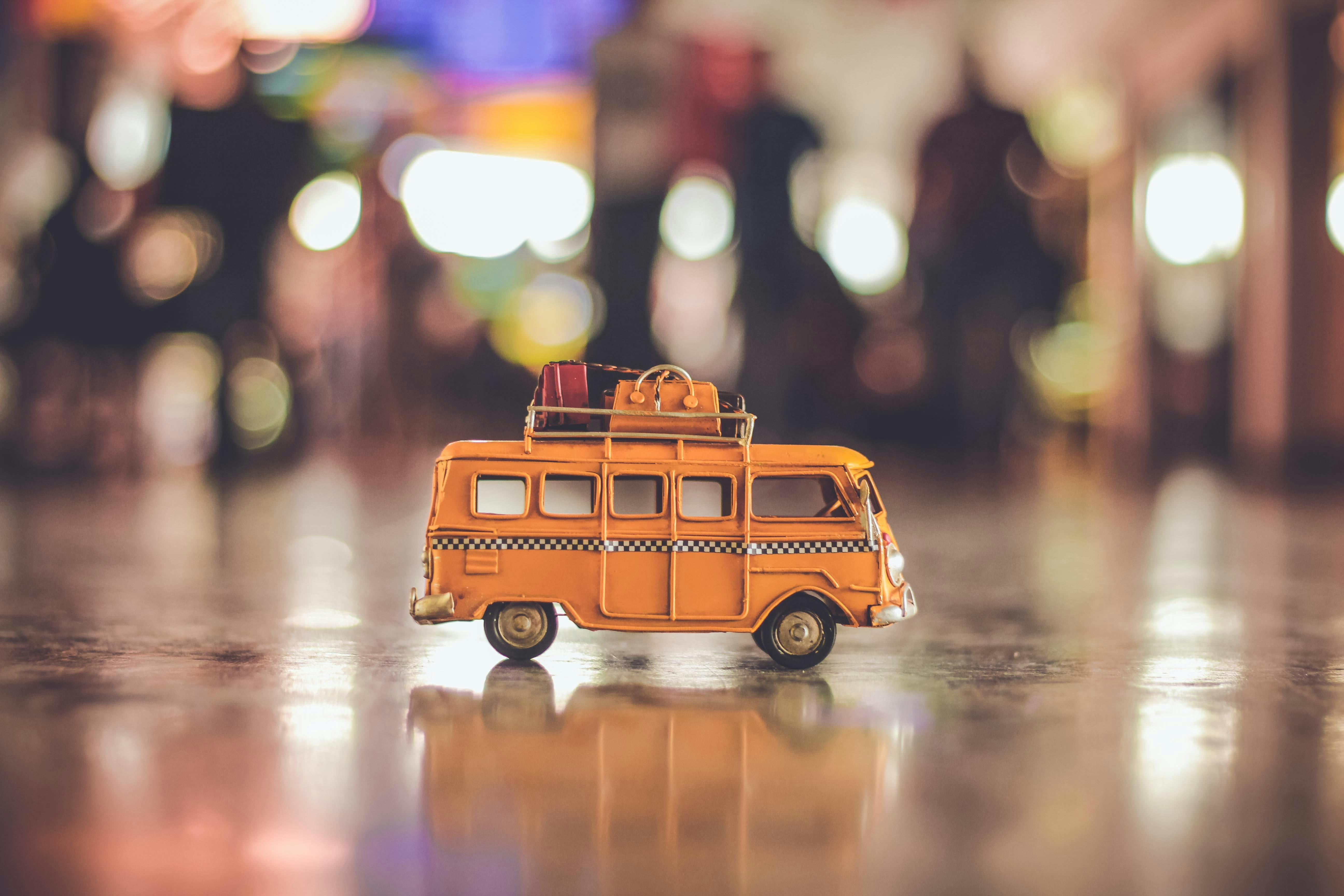 selective focus photography of yellow school bus scale model