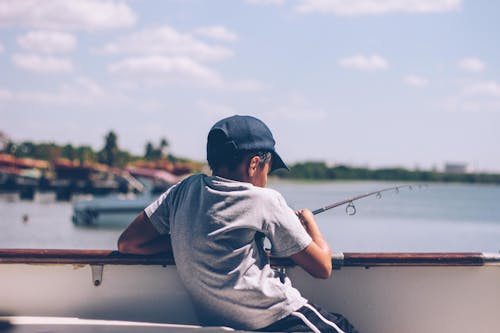 Free Boy Holding Fishing Rod Stock Photo