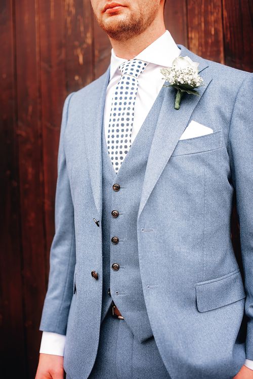 Free Groom in a blue suit and floral boutonniere, perfect for a wedding setting. Stock Photo