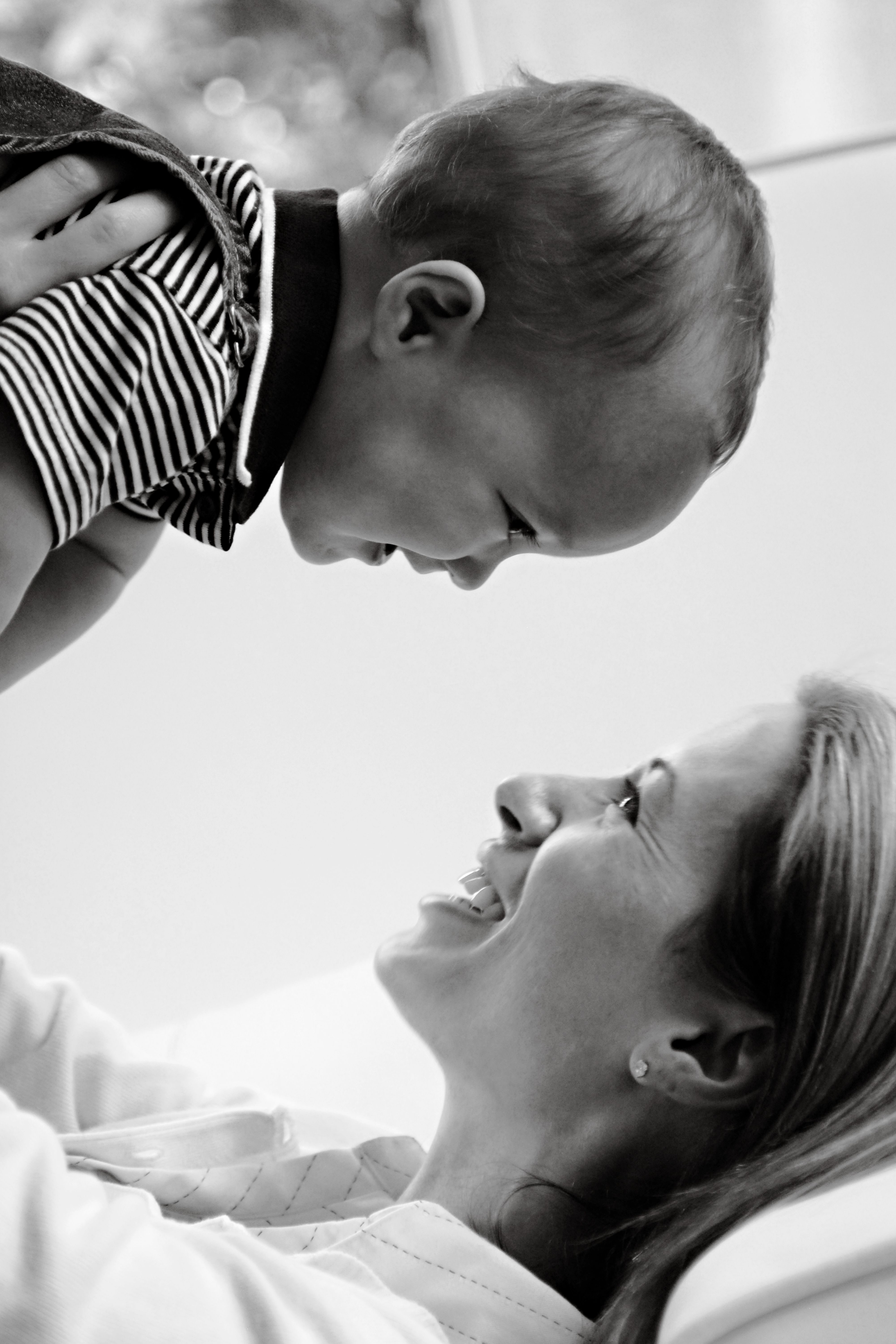 A touching black and white portrait capturing a joyful moment between mother and child.