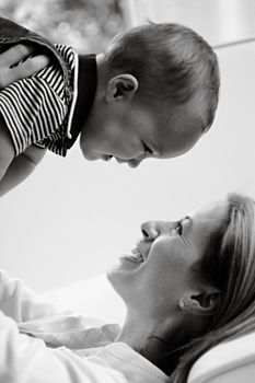 A touching black and white portrait capturing a joyful moment between mother and child.
