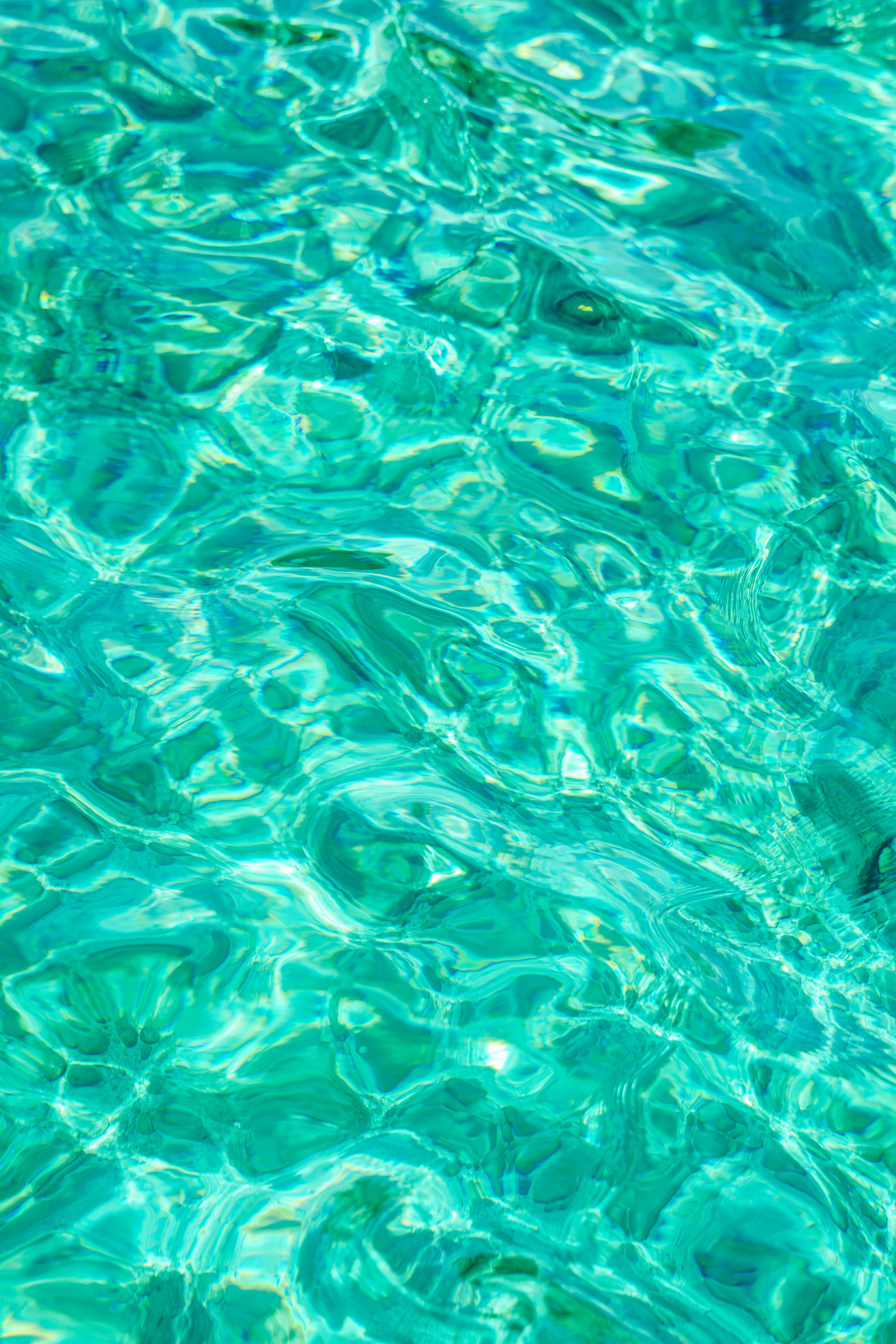 Vibrant turquoise water with ripples creating a mesmerizing texture and pattern.