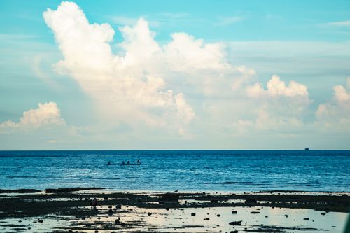 Free Relaxing seaside view with calm ocean waves and a picturesque cloudy sky. Stock Photo
