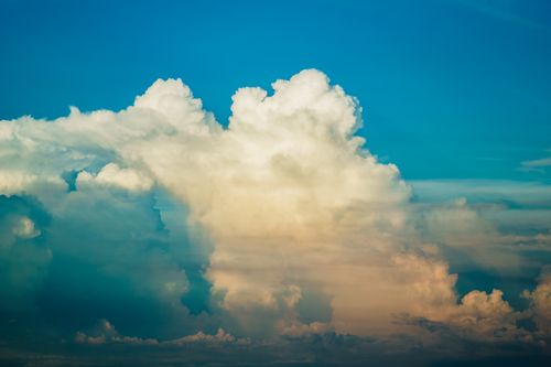 Free Vivid cumulus clouds tower against a clear blue sky, capturing a stunning aerial scene. Stock Photo