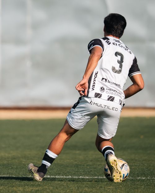 Free A soccer player mid-action during a game, wearing number 3 jersey. Stock Photo