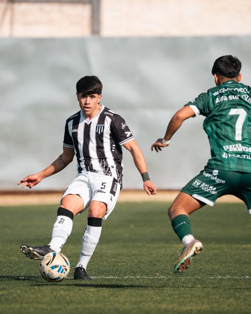 Free Two soccer players in action on the field during a sunny day match. Stock Photo