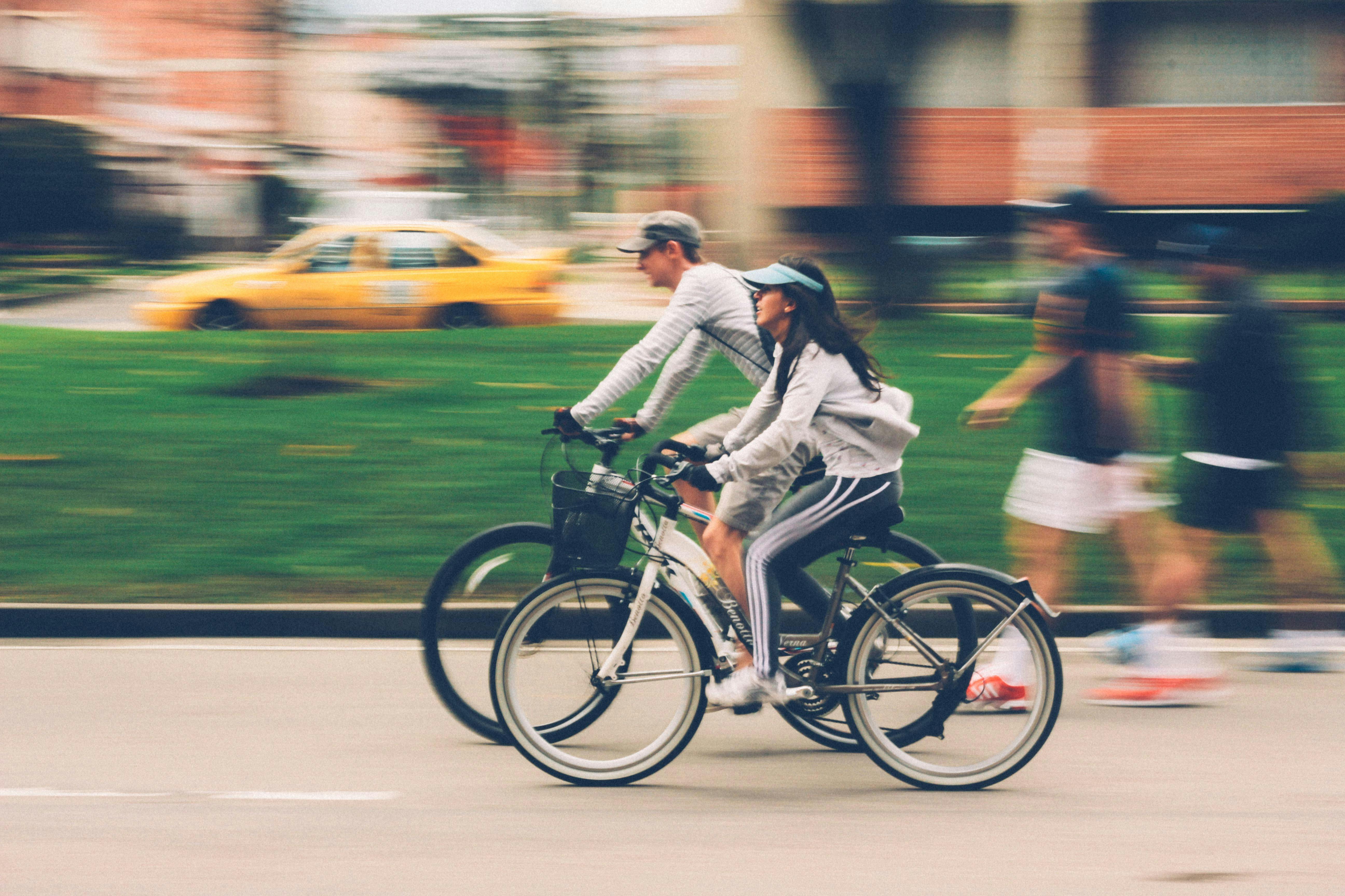 A man and a woman riding bikes