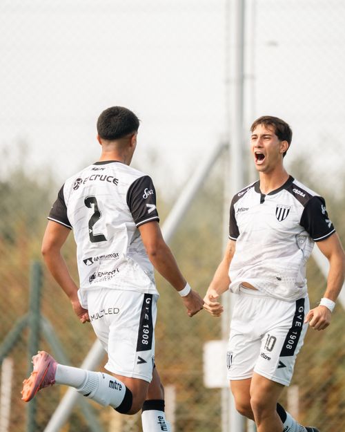 Free Two young soccer players passionately celebrating a goal on the field. Stock Photo