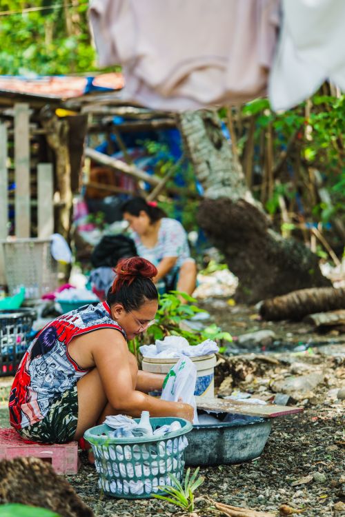 Free Two women washing clothes outdoors in a rural setting, showcasing traditional laundry methods. Stock Photo