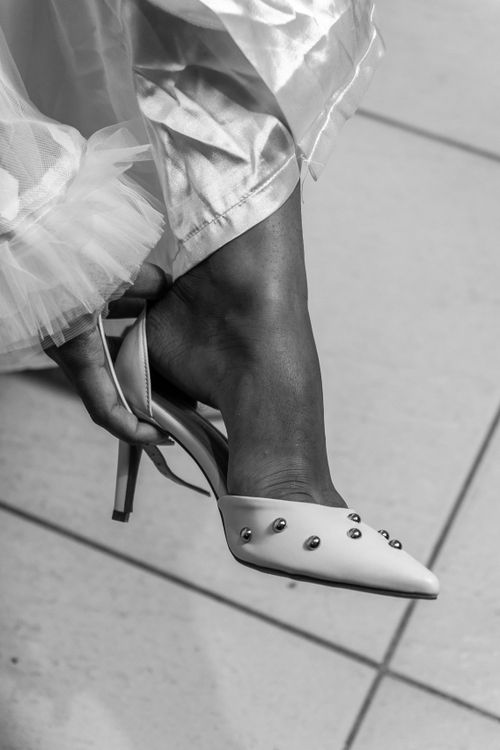 Free Close-up of a bridal shoe and tulle skirt, emphasizing elegance and style. Stock Photo