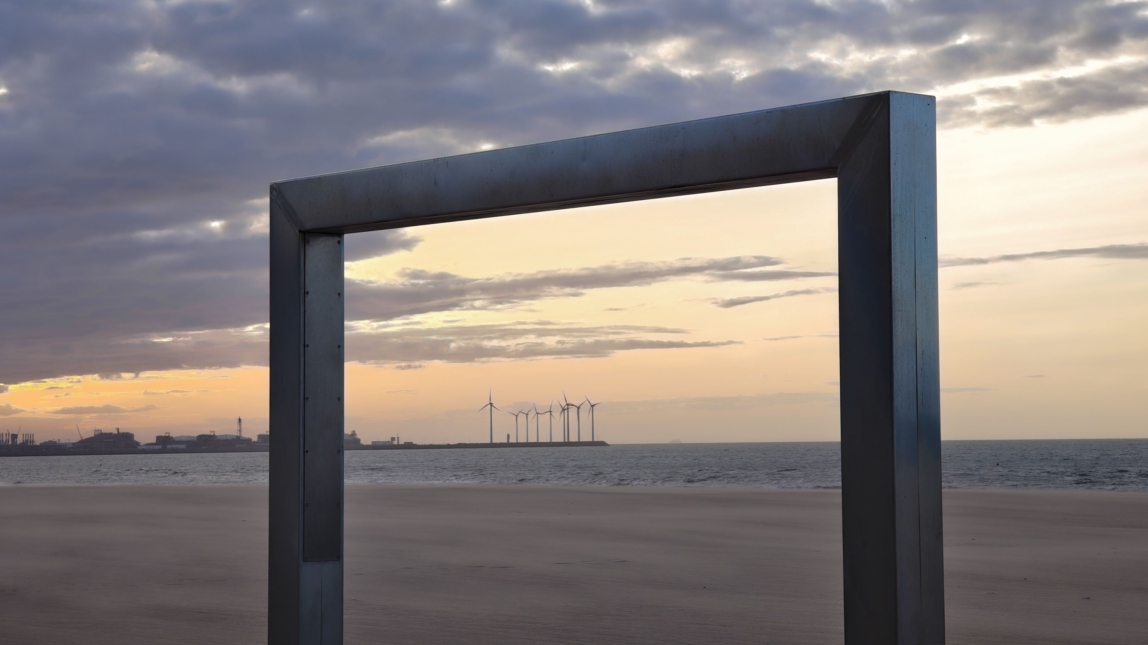 Captivating sunset over wind turbines framed on Knokke-Heist beach, Belgium.