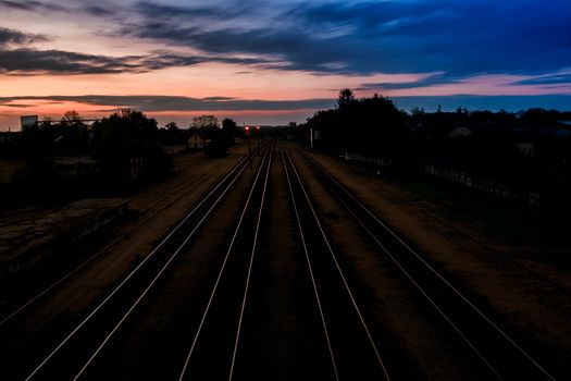 Stainless Steel Train Rails Under Cloudy Sky