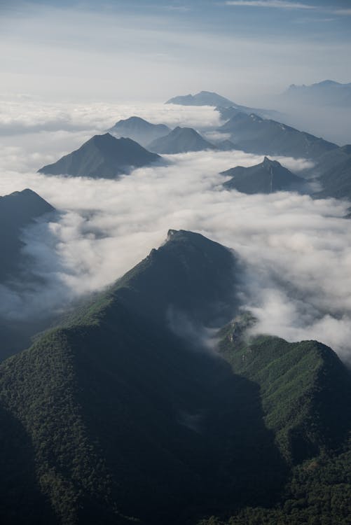 Free Green Mountains On White Low Clouds Stock Photo