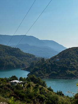 Explore the serene landscape of a lake surrounded by hills in Antalya, Türkiye.