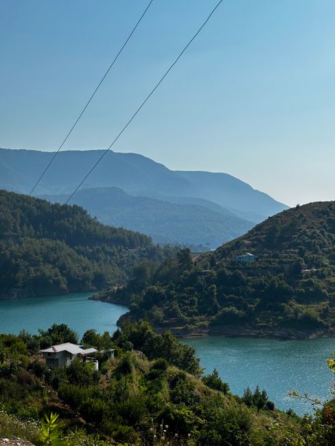 Explore the serene landscape of a lake surrounded by hills in Antalya, Türkiye.