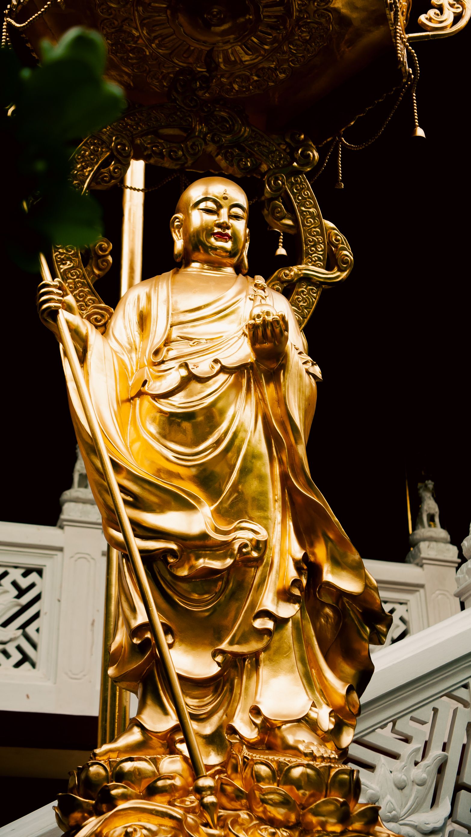 Golden Buddha statue at a temple in Ho Chi Minh City, symbolizing peace and spirituality.