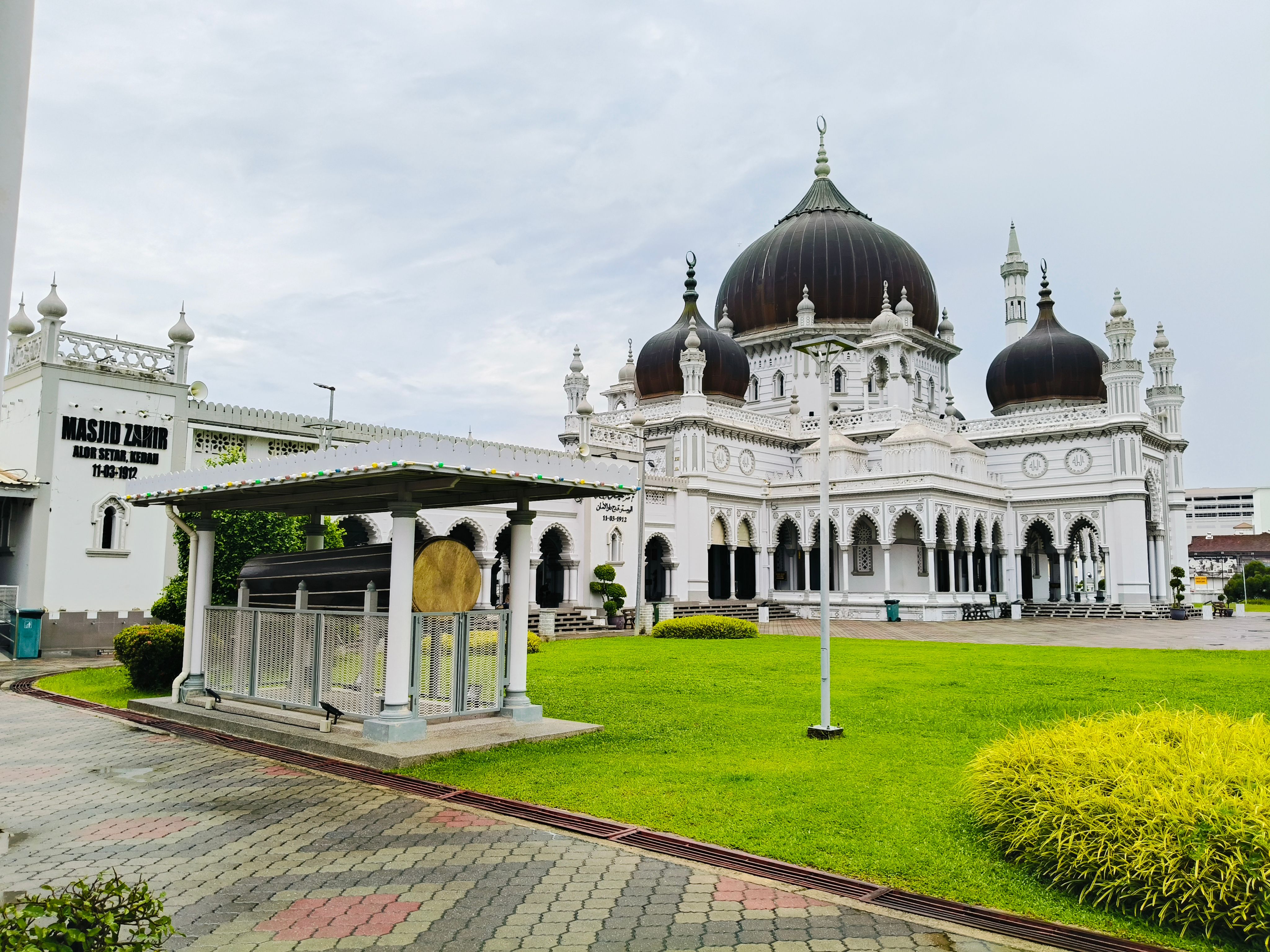 Beautiful Zahir Mosque in Alor Setar, Malaysia, showcasing Islamic architecture and lush surroundings.