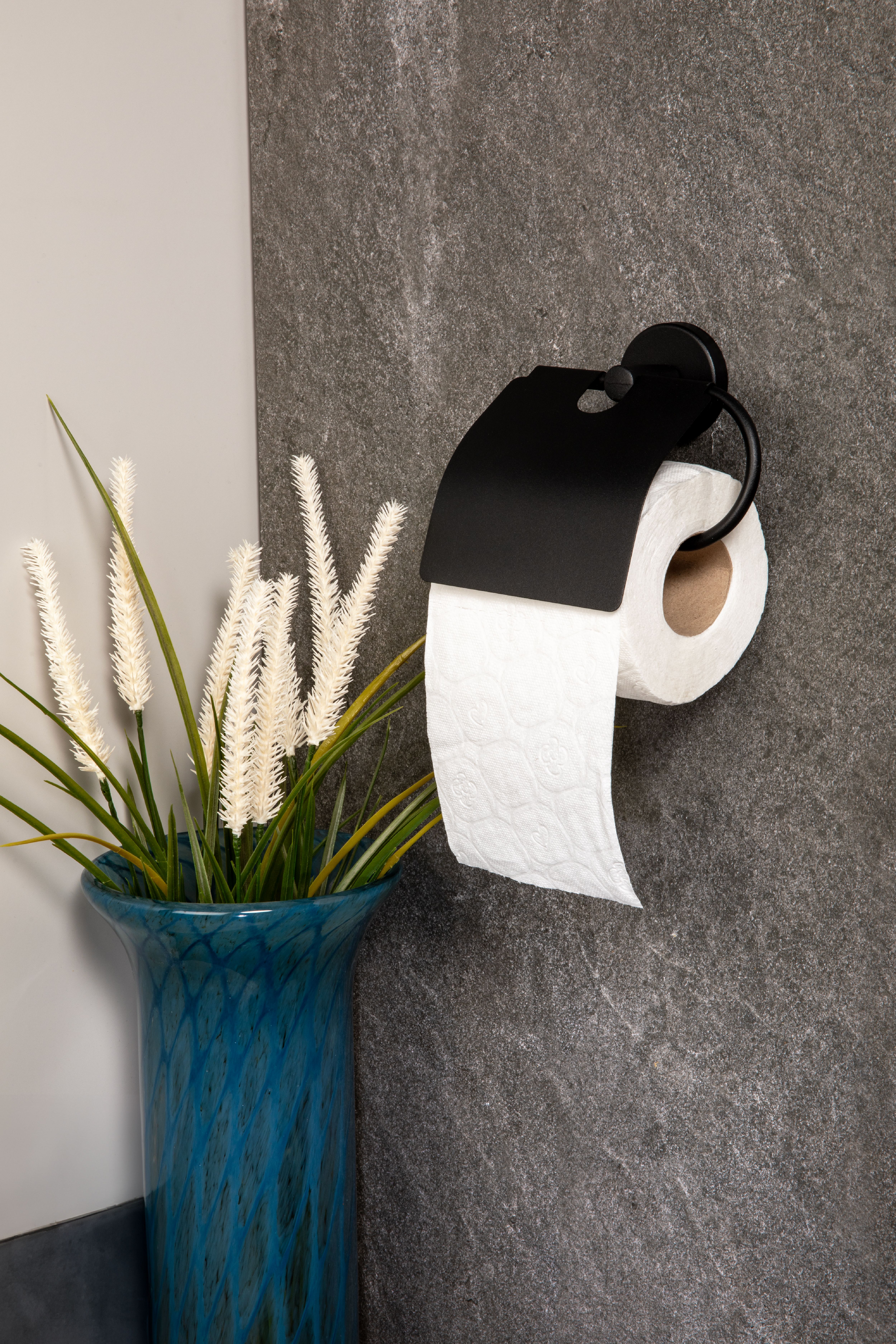 Toilet paper holder on a bathroom wall