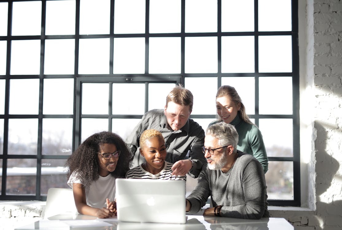 Free Group of People Watching On A Laptop Stock Photo
