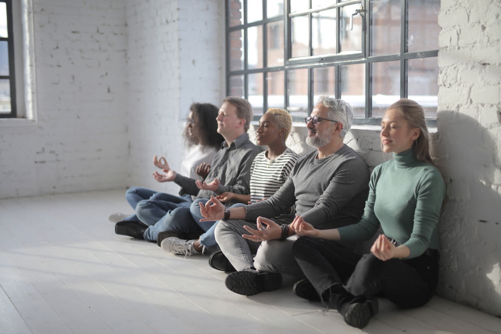 Colleagues taking part in a workplace meditation session