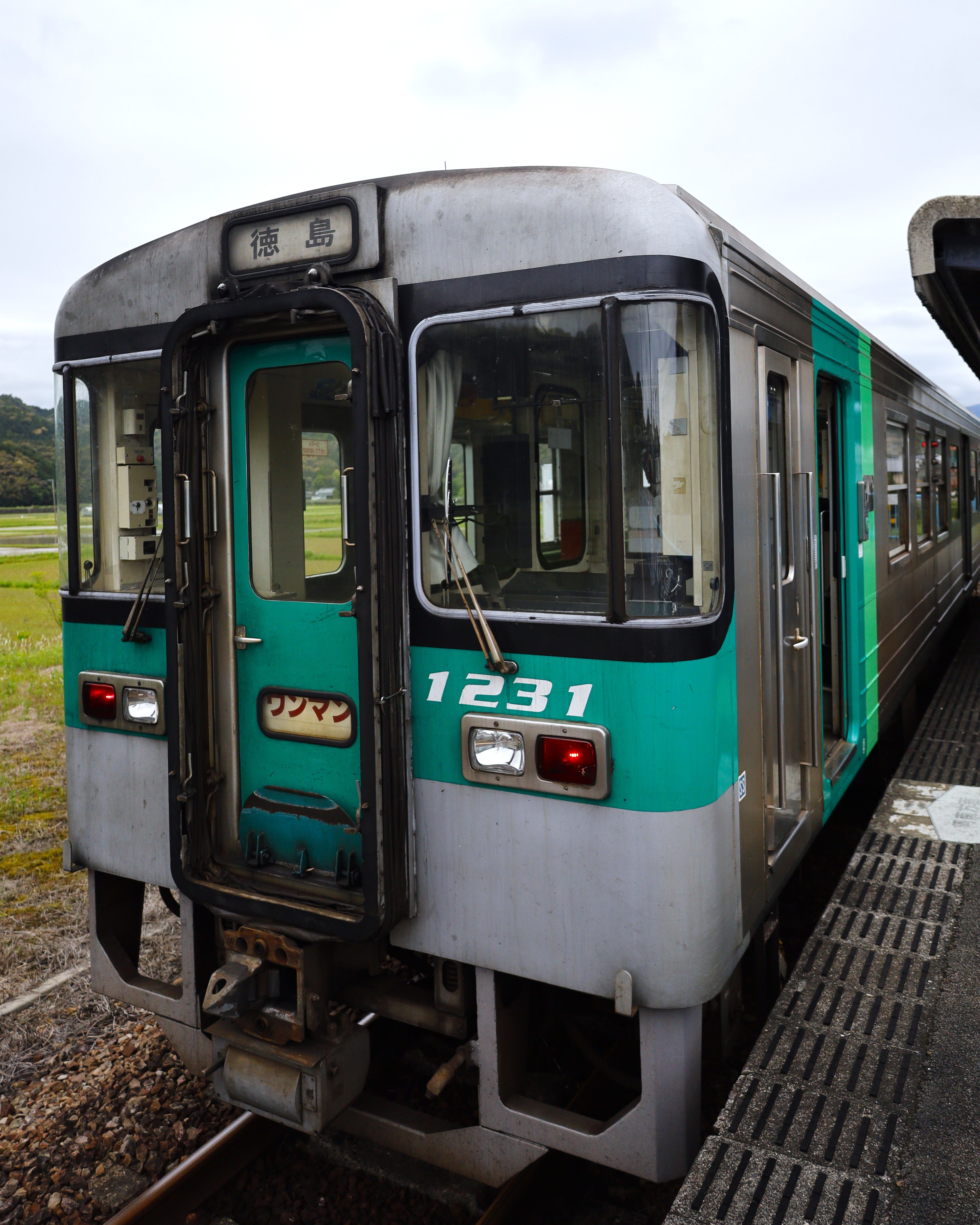 A JR Shikoku commuter train at the station platform in Kaiyō, Tokushima, Japan.