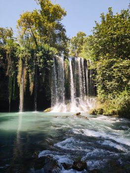 Beautiful waterfall cascading amidst lush greenery in Antalya, Türkiye.