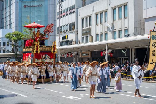 Participants in traditional costumes march during Kyoto's Gion Matsuri festival parade.