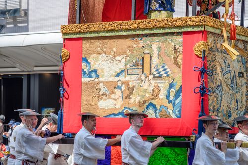 Free Intricate Japanese parade float carried by participants in traditional attire during a festival. Stock Photo
