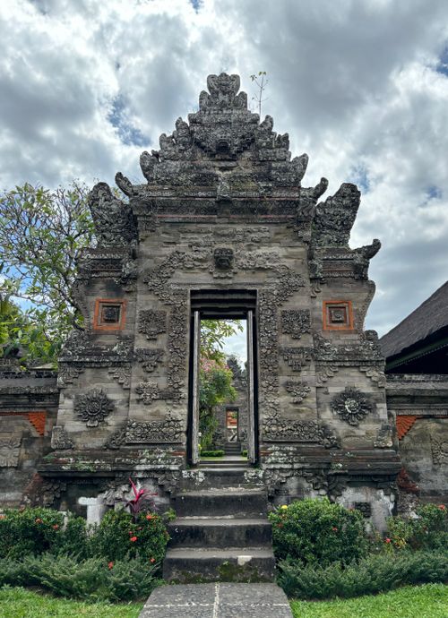 Free Ornate temple gate with traditional carvings in Bali, showcasing Indonesian cultural architecture. Stock Photo
