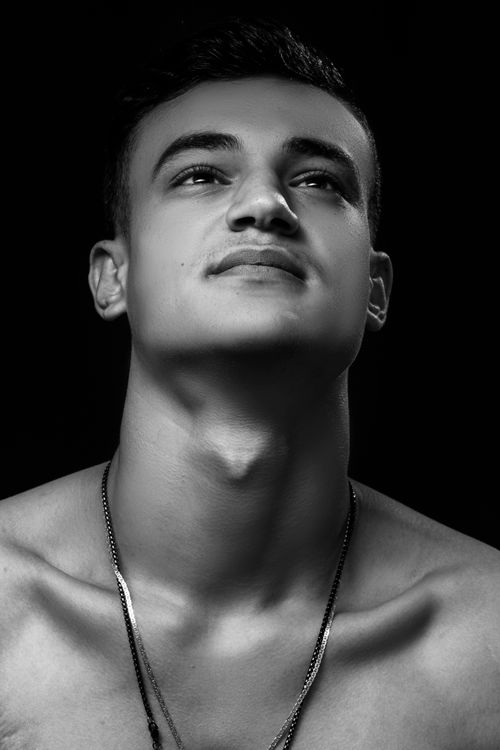 Free Striking monochrome portrait of a young man looking up with a calm expression. Stock Photo