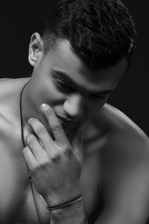 Grayscale Photo of Topless Man Wearing Silver Necklace