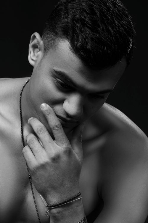 Free Artistic black and white portrait of a shirtless man lost in thought. Stock Photo