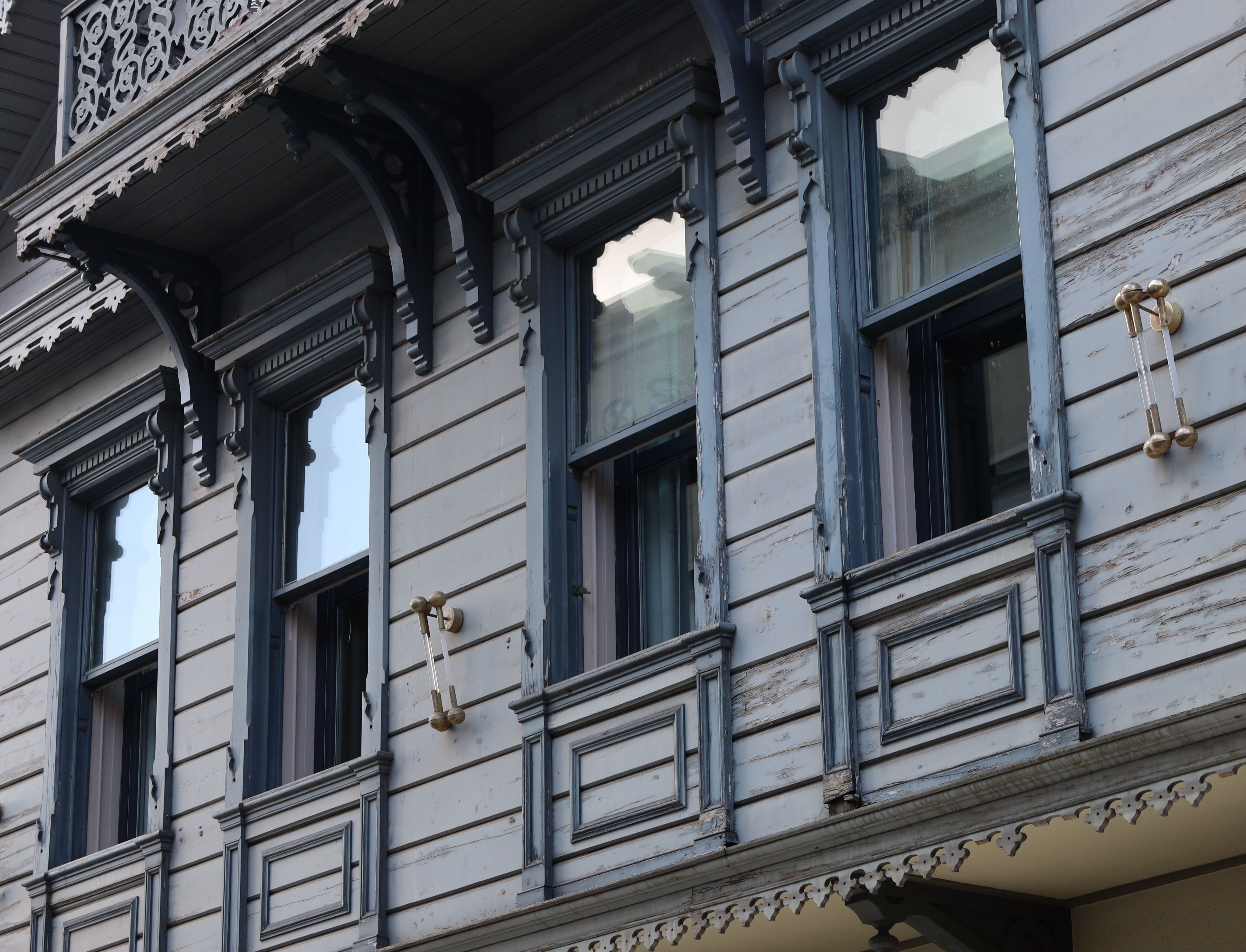 Close-up of a Victorian-style building facade with ornate window details.