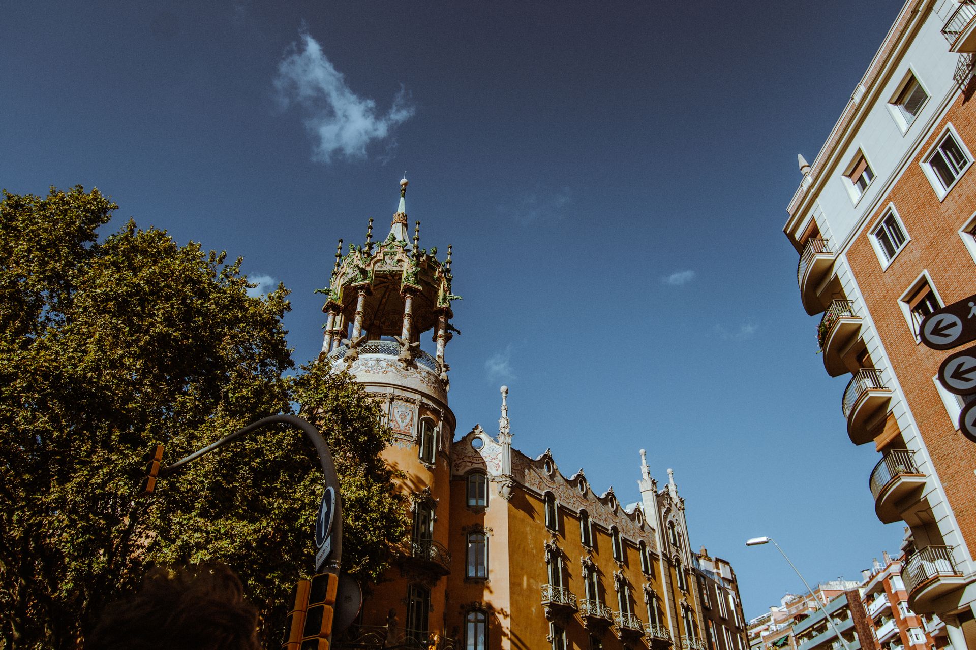 A beautiful historic building in Barcelona adorned with intricate details under a clear blue sky, showcasing stunning architecture.