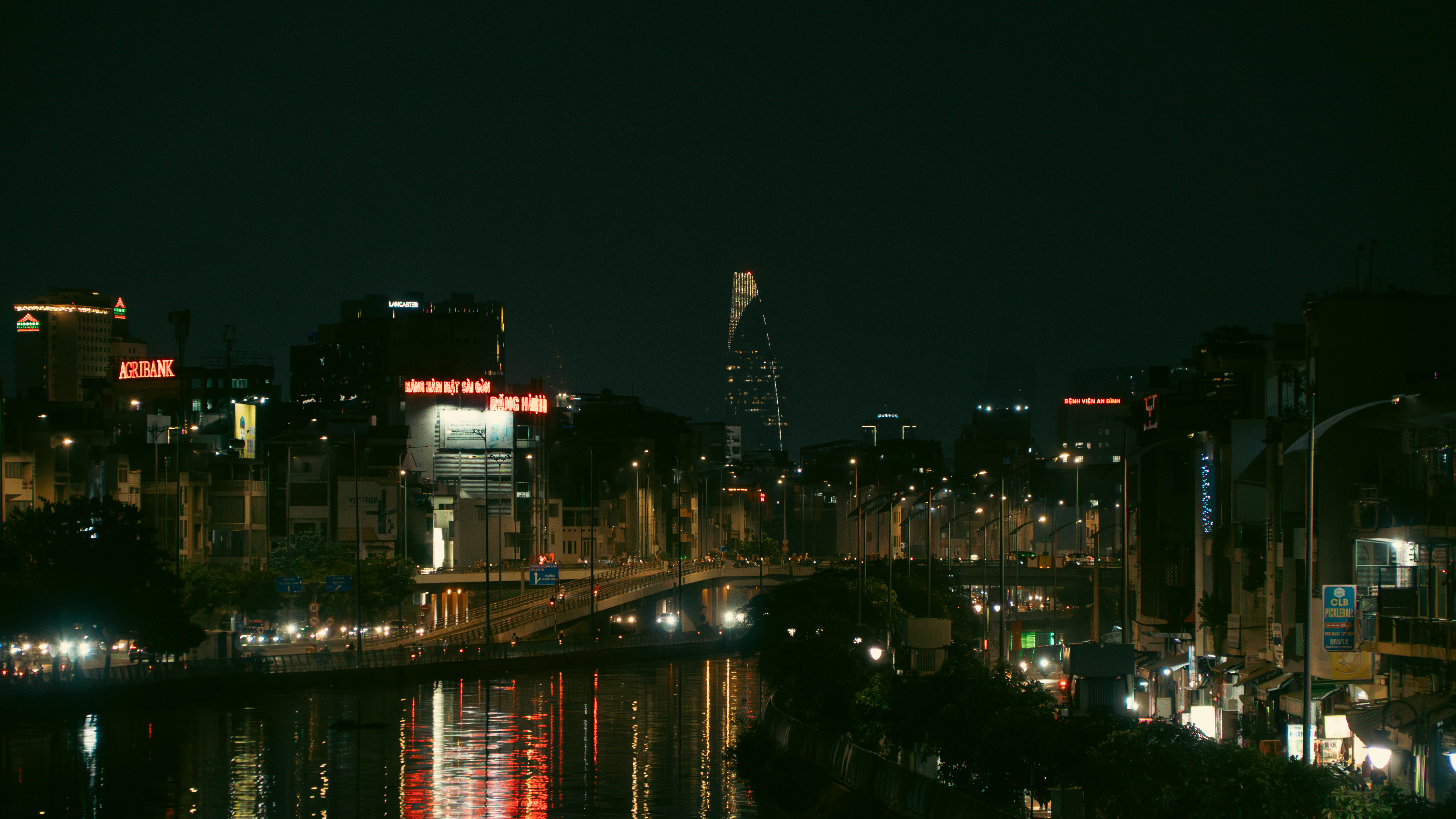 Ho Chi Minh City skyline and lights reflecting on the Saigon River at night