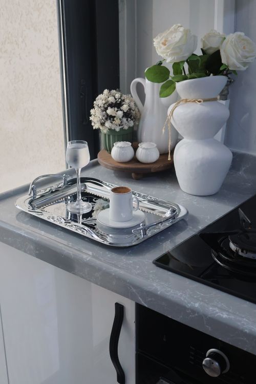 Free Stylish coffee and vase setup on kitchen counter with flowers and natural light. Stock Photo