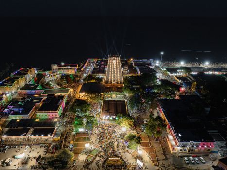 Stunning aerial view of Thiruchendur temple illuminated at night during a vibrant festival.