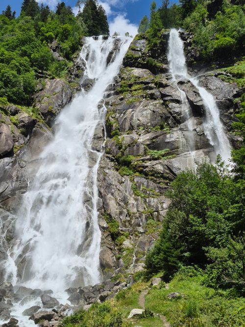 Free Majestic waterfall in Trentino-Alto Adige, Italy, surrounded by lush greenery. Stock Photo
