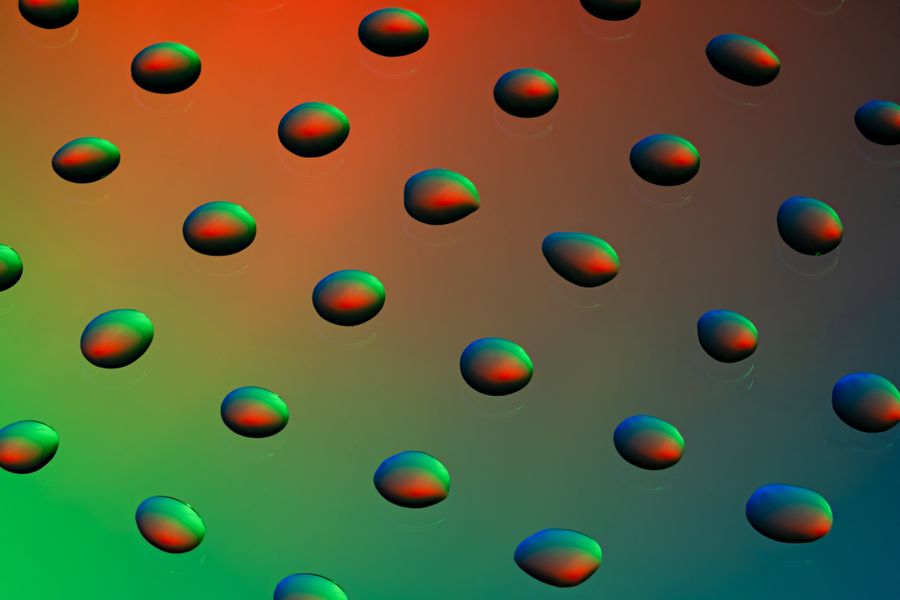 Vibrant and colorful abstract image featuring droplet patterns with a gradient background, artistic and striking.