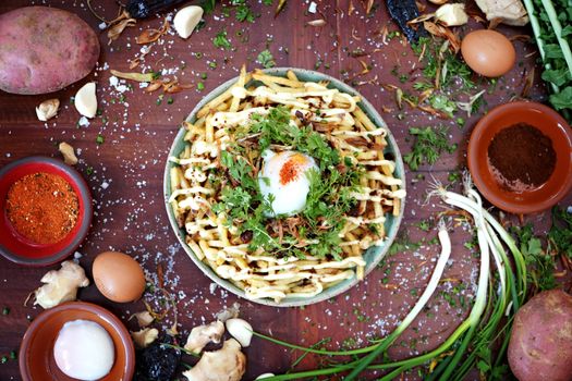 Delicious gourmet fries topped with poached egg, herbs, and spices. Perfect for food lovers and culinary enthusiasts.